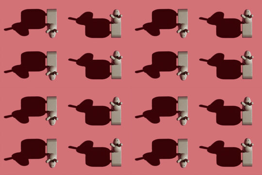 Pattern of small brown donkey figurines against pastel red background