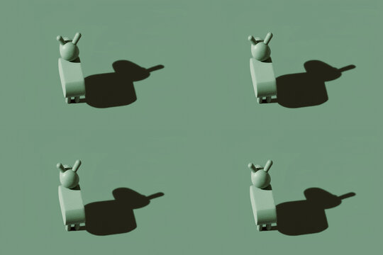 Pattern of small green donkey figurines against pastel green background