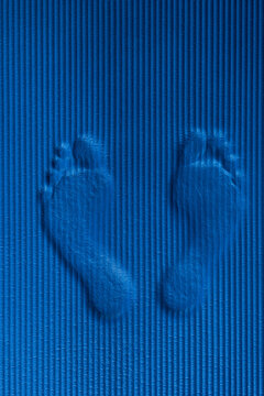 Footmarks on blue workout mat
