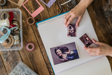 Top view of woman's hands designing photo album