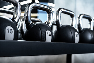 Naklejka na ściany i meble Close up of new dumbbells on a rack in a gym