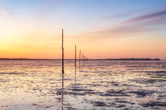 United Kindom, England, Northumberland, posts marking the pilgrims way crossing to Lindisfarne, Holy Island