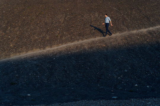 Mature businessman walking on a disused mine tip