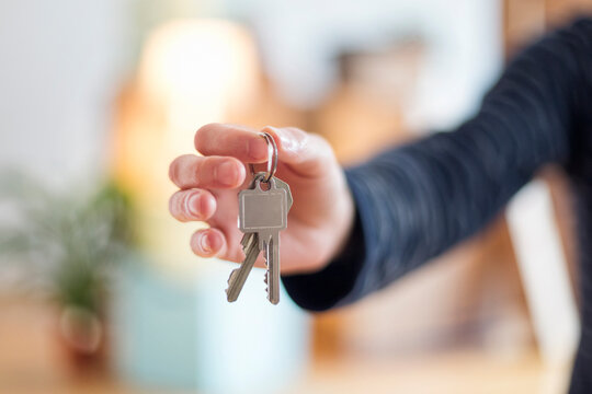 Close-up of man holding house key in new home