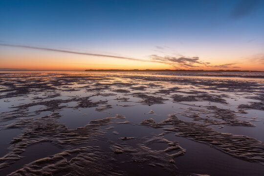 United Kingdom, Northumberland, mudflats at sunrise