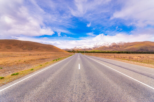 Diminishing view of State Highway 8 against sky, Tekapo, South Island, New Zealand