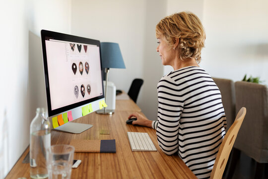 Mature woman using desktop at home