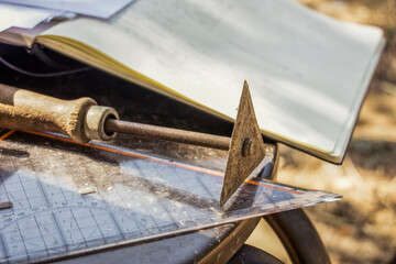 Greece, Olympia,ÔøΩArchaeological trowel, set square and documentation book