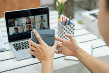 Online studying concept the man in plain white T-shirt feeling quite happy and holding the calculator for calculating numbers in accounting class