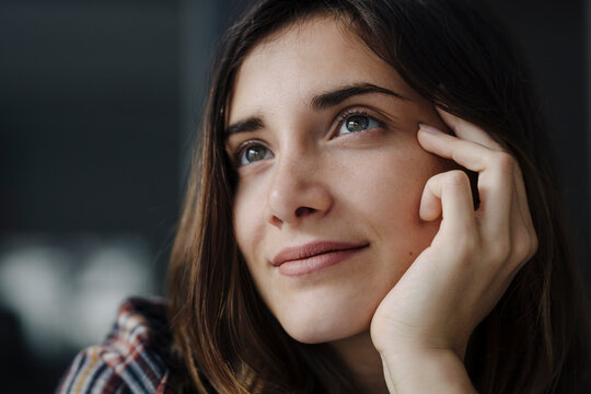 Portrait of daydreaming young woman