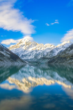 New Zealand, South Island, Mount Cook reflecting on shiny surface of Hooker Lake