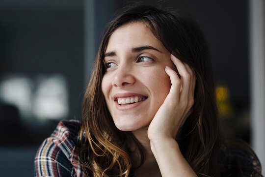 Portrait of happy young woman looking at distance
