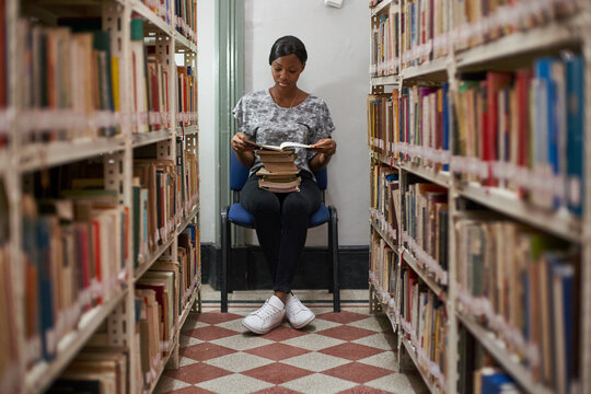 Young woman reading a book at National library, Maputo, Mocambique
