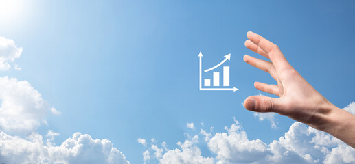 Male hand holding smart mobile phone with graph icon.checking analyzing sales data growth graph...