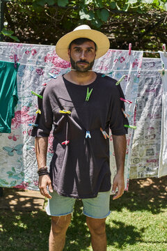 Man fixed with clothes pegs at a clothesline