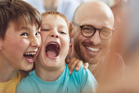 Father and sons having fun at home