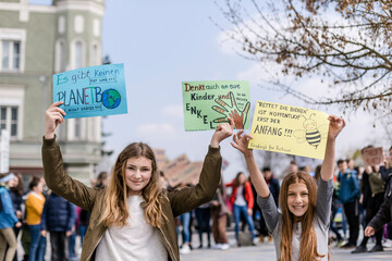 Girl holding a placard on a demonstration for environmentalism