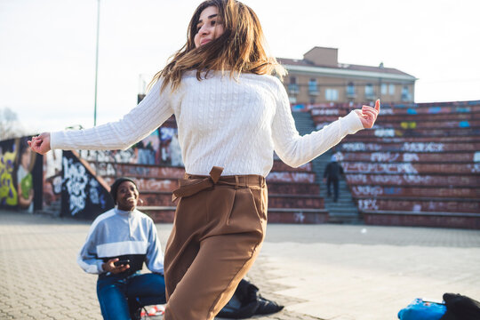 Young dancers rehearsing in a skare park