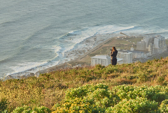 Woman taking pictures from the top of a hill, Signal Hill, South Africa