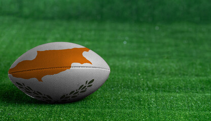 American football ball  with Cyprus flag on green grass background, close up