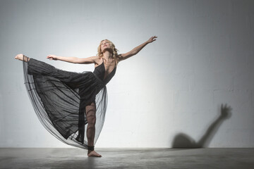 Blond woman dancing in black dress