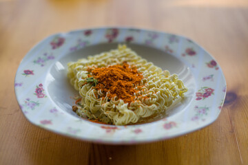 instant noodles with spices in a plate