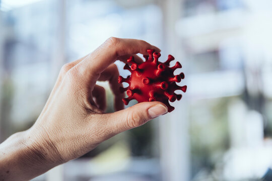 Hand holding model of corona virus, close up