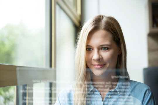 Businesswoman using futuristic tablet, glass pane