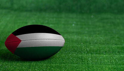 Fototapeta na wymiar American football ball with Palestine flag on green grass background, close up