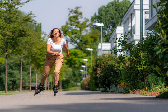 Young woman inline skating in the city, Waiblingen, Germany
