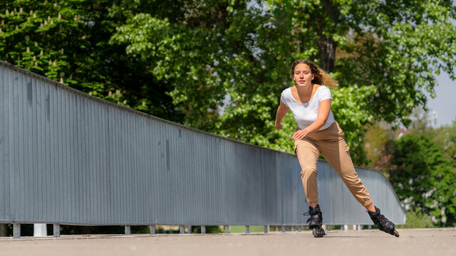 Young woman inline skating in the city, Waiblingen, Germany