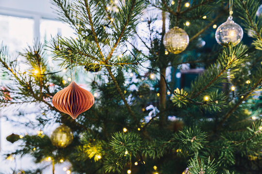 Closeup of decorated pine Christmas tree in living room