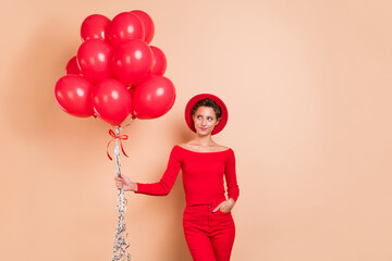 Photo of dreamy pretty nice woman look empty space red balloons season sale isolated on beige color background