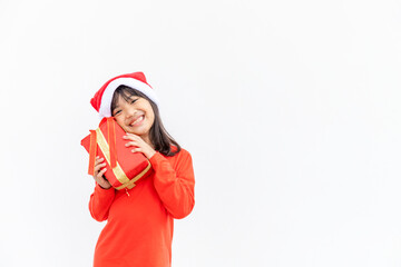 Happy Asian child in Santa red hat holding Christmas presents. Christmas time.on white background.