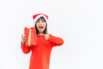 Happy Asian child in Santa red hat holding Christmas presents. Christmas time.on white background.