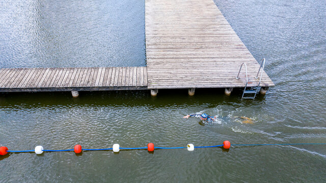 Aerial view of a triathlete crawling in a lake
