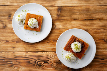 Turkish dessert kunefe served with ice cream on wooden background