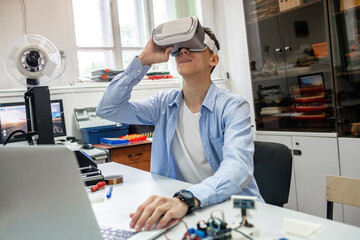 Student using 3D printer and VR goggles