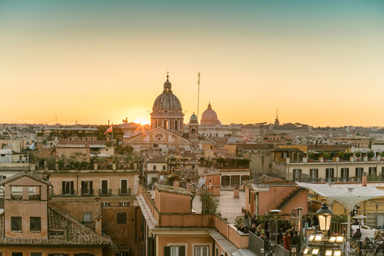 The skyline of Rome with San Carlo al Corso and St. Peter's Basilica before sunset seen from the Spanish Steps, Italy