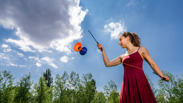 Young woman juggling with diablo