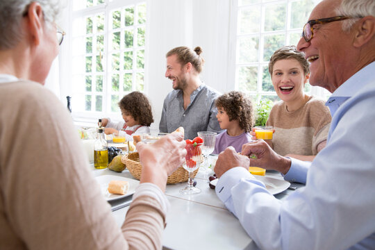 Happy extended family having lunch at home