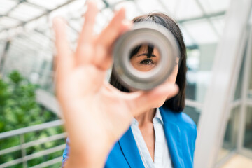 Female entrepreneur doing quality control of equipment at office