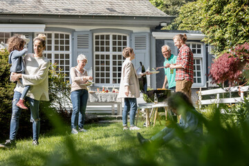 Extended family having a barbecue in garden
