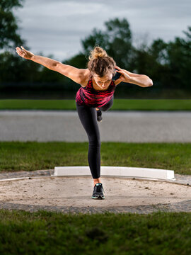 Femal shot-putter training with ball