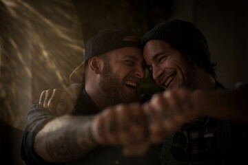 Friends holding fists together, showing their tattoos
