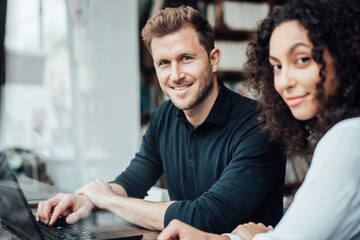 Business people smiling while sitting at cafe