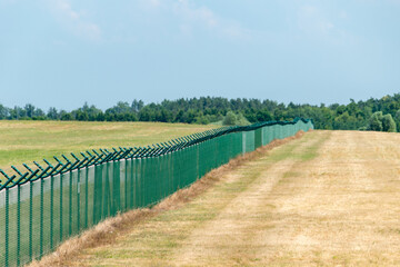 Security fence of an international airport in Poland.