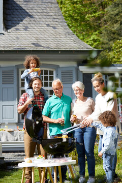 Happy extended family having a barbecue in garden