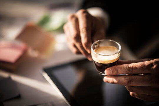 Businessman holding cup of coffee in his office