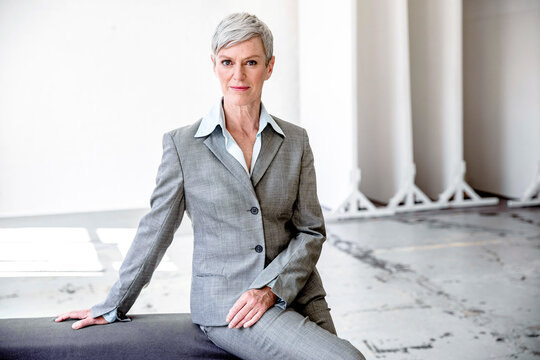 Portrait of mature businesswoman  wearing grey pantsuit